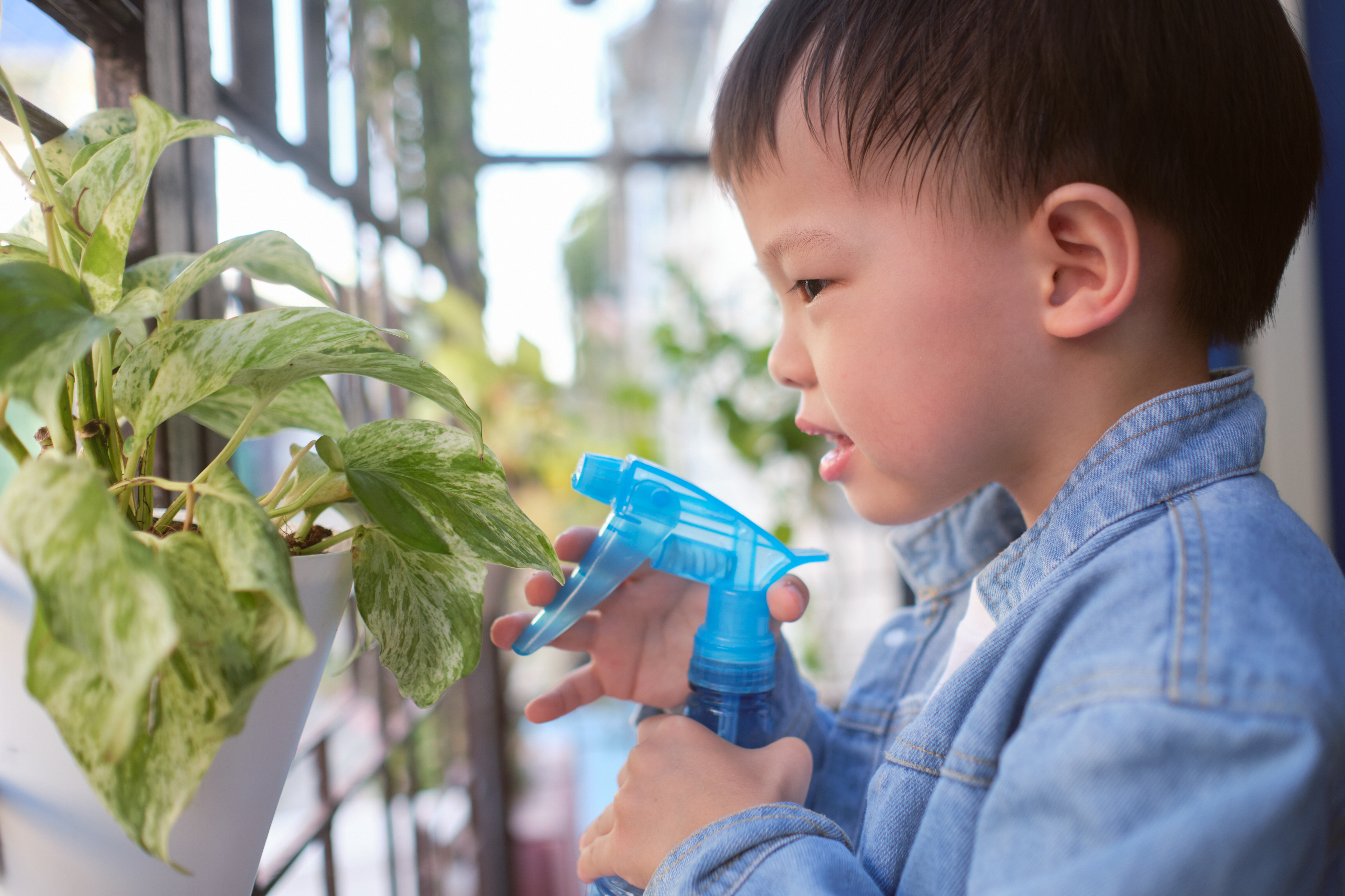 Child pouring water in Montessori activity